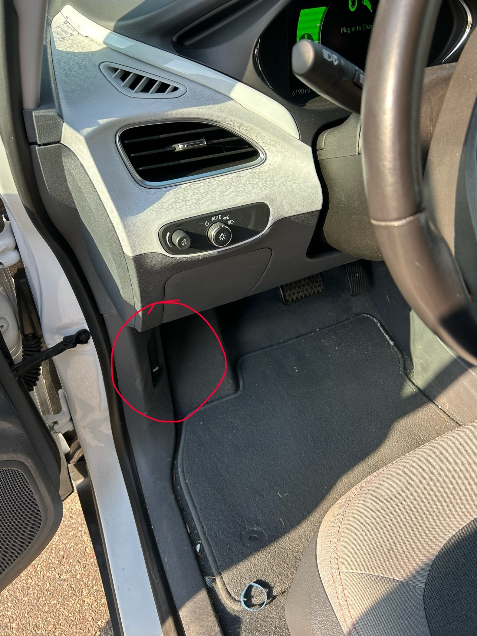 A picture showing the tab you pull to open the hood of a Chevy Bolt.